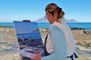 Beginner artist painting waterfront